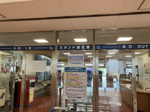 Entrance to the 4th-floor reserved seating area at BOAT RACE Heiwajima, marked with IN and OUT signs.